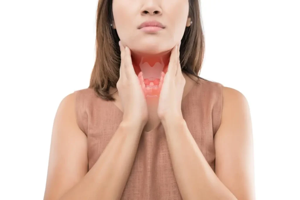 Illustration showing a transparent overlay of the thyroid gland and larynx on a woman’s neck to highlight endocrine anatomy.