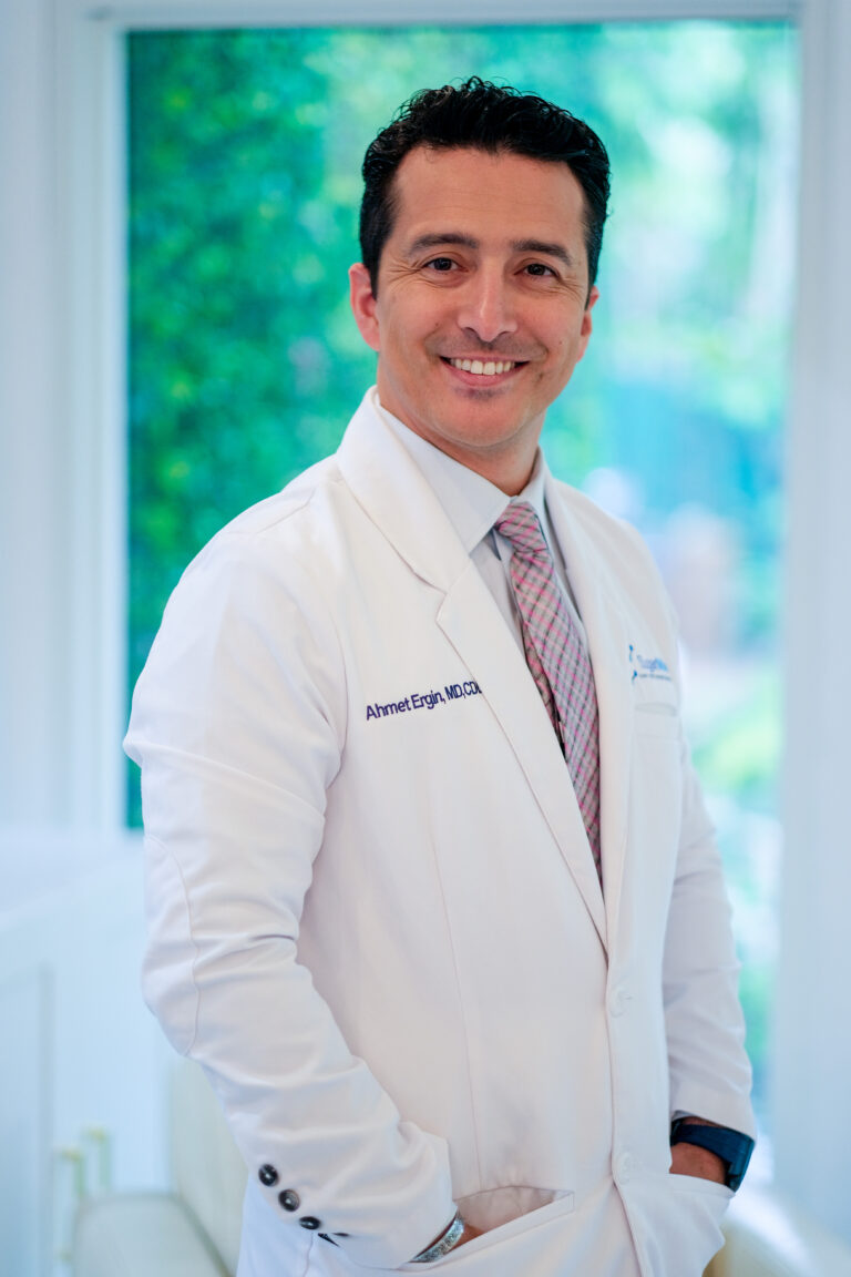 Portrait of Dr. Ahmet Ergin, a board-certified endocrinologist and diabetes specialist, in a white medical coat.