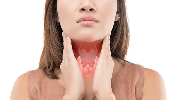 A woman in a white dress holding her hand to her throat with a red butterfly-shaped thyroid gland anatomical overlay highlighted.
